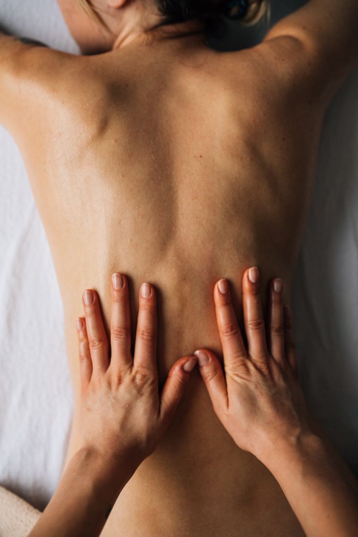 Mastering the First Impression: Your intriguing post title goes here Hands massaging a person's back for relaxation in a calming indoor setting.